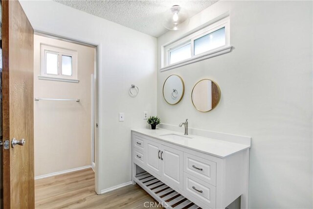 1593 W Carter St, Bloomington, CA 92316 - bathroom with vanity, a textured ceiling, and wood finished floors