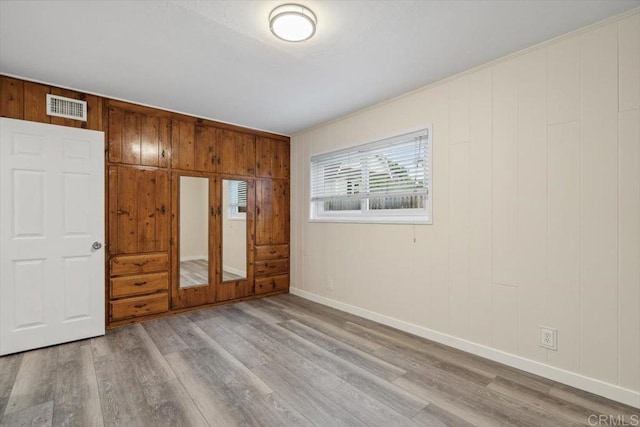 8123 Palm St, Lemon Grove, CA 91945 - unfurnished bedroom featuring wood finished floors and wooden walls
