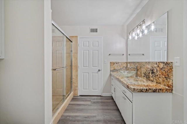 8123 Palm St, Lemon Grove, CA 91945 - bathroom with vanity, a stall shower, wood finished floors, and tasteful backsplash