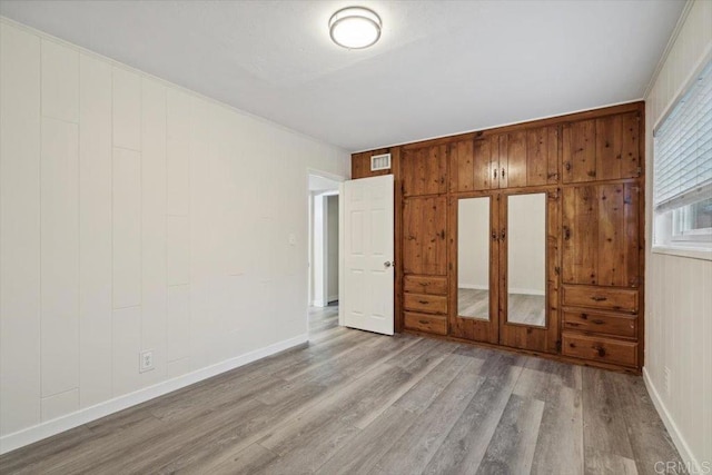 8123 Palm St, Lemon Grove, CA 91945 - unfurnished bedroom featuring wood finished floors and wooden walls
