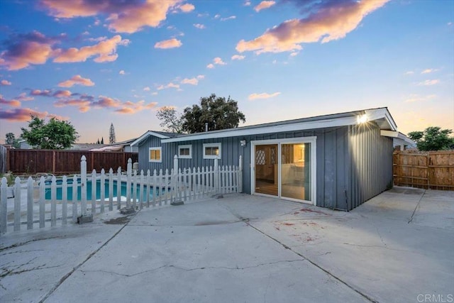 8123 Palm St, Lemon Grove, CA 91945 - back of house featuring board and batten siding, a patio, and a fenced backyard