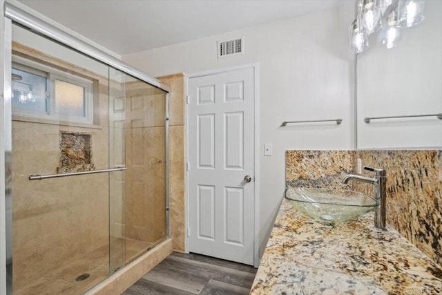 8123 Palm St, Lemon Grove, CA 91945 - bathroom with a stall shower, wood finished floors, decorative backsplash, and vanity