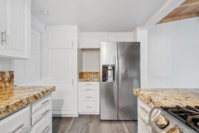 8123 Palm St, Lemon Grove, CA 91945 - kitchen with stainless steel refrigerator with ice dispenser, white cabinets, wood finished floors, light stone counters, and wooden walls
