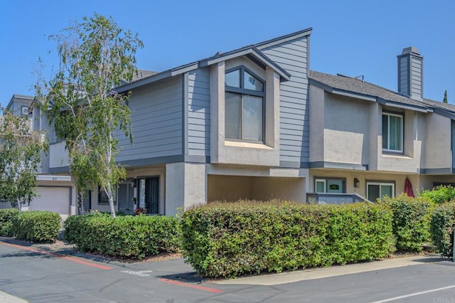 2135 E Valley Pkwy Unit 52, Escondido, CA 92027 - view of side of home featuring a chimney and stucco siding