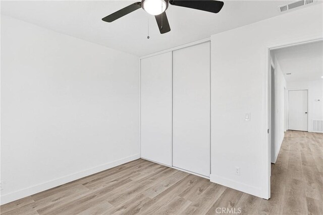 9546 San Pablo Ave, Hesperia, CA 92345 - unfurnished bedroom with light wood finished floors, a closet, and a ceiling fan