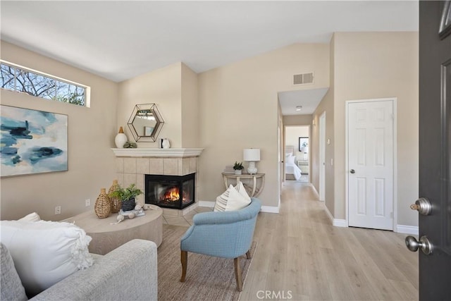 20 Via Jolitas, Rancho Santa Margarita, CA 92688 - living area with light wood-style flooring, a tiled fireplace, and lofted ceiling