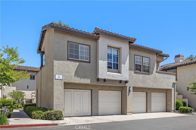 20 Via Jolitas, Rancho Santa Margarita, CA 92688 - view of front of house featuring a garage, stucco siding, and a tile roof