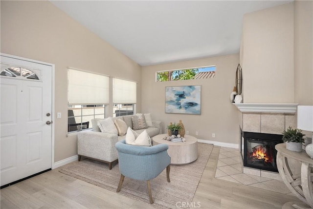 20 Via Jolitas, Rancho Santa Margarita, CA 92688 - living area featuring light wood-style flooring, a tile fireplace, and vaulted ceiling