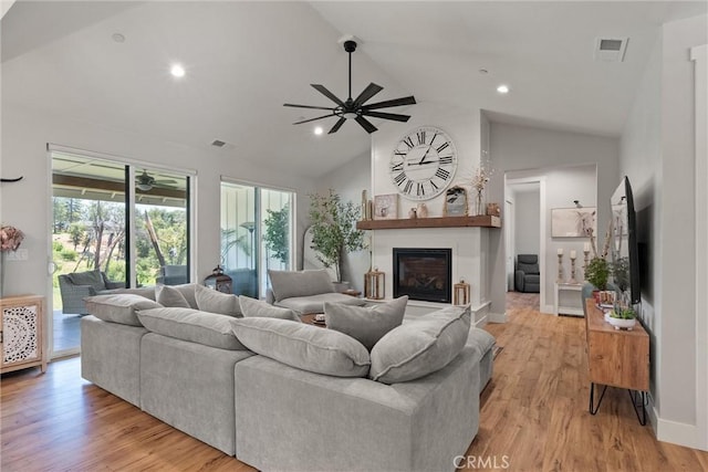 212 Valley View Dr, Paradise, CA 95969 - living room featuring ceiling fan, plenty of natural light, a glass covered fireplace, high vaulted ceiling, and light wood-style floors