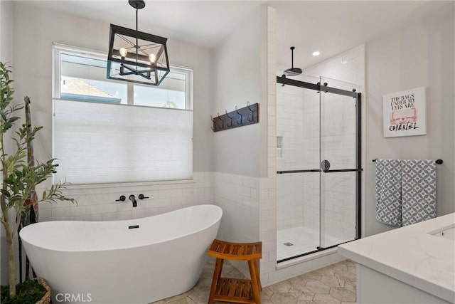 212 Valley View Dr, Paradise, CA 95969 - full bathroom with a shower stall, a soaking tub, vanity, a chandelier, and tile walls