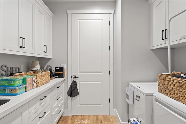 212 Valley View Dr, Paradise, CA 95969 - laundry room with cabinet space, washer and clothes dryer, and light wood finished floors
