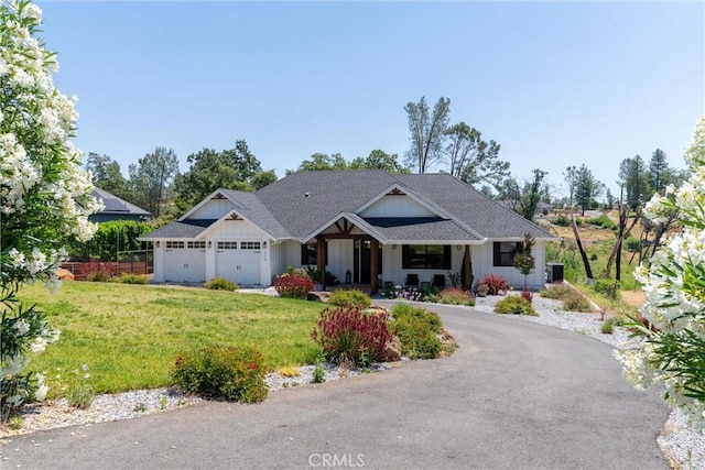 212 Valley View Dr, Paradise, CA 95969 - view of front of property featuring an attached garage, a front yard, driveway, board and batten siding, and roof with shingles