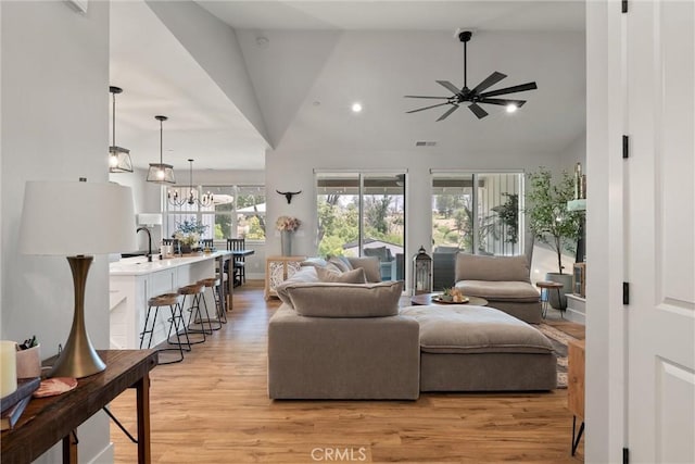 212 Valley View Dr, Paradise, CA 95969 - living room featuring ceiling fan, light wood-style floors, high vaulted ceiling, and a chandelier