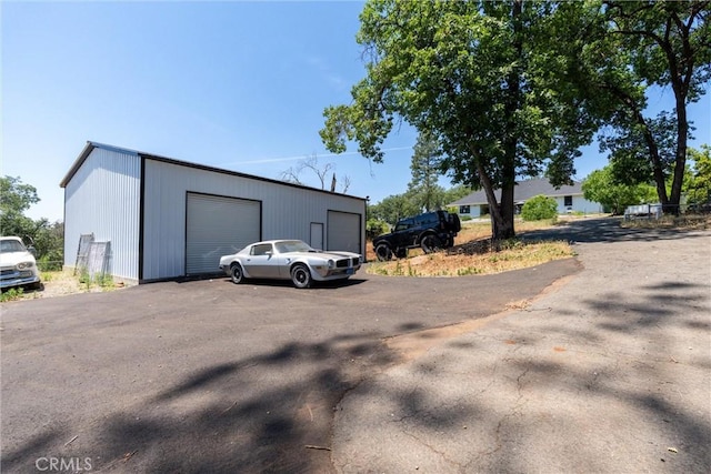 212 Valley View Dr, Paradise, CA 95969 - view of side of home featuring a detached garage and an outbuilding