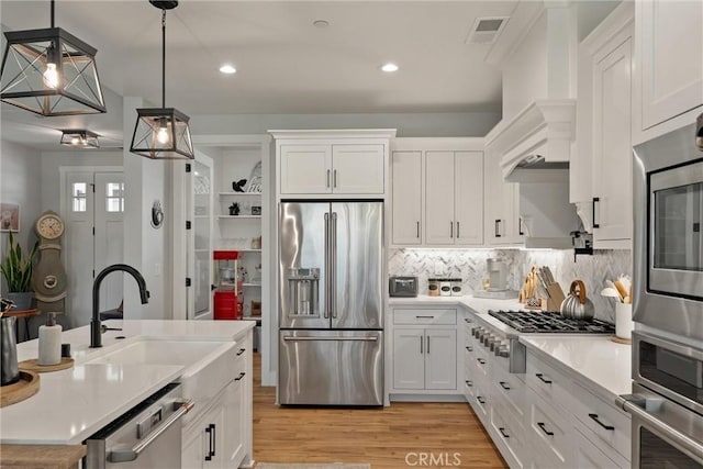 212 Valley View Dr, Paradise, CA 95969 - kitchen featuring appliances with stainless steel finishes, white cabinetry, light countertops, light wood-style flooring, and recessed lighting