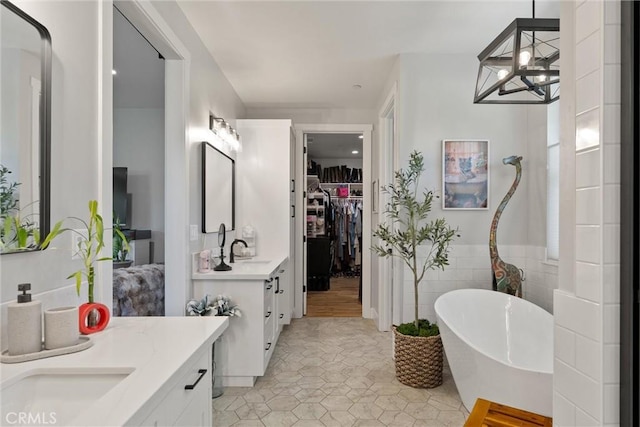 212 Valley View Dr, Paradise, CA 95969 - bathroom featuring vanity, a freestanding tub, a chandelier, a walk in closet, and tile patterned floors