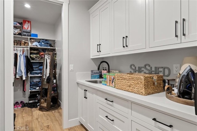 212 Valley View Dr, Paradise, CA 95969 - laundry area featuring a sink and light wood-type flooring