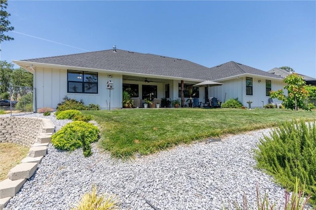 212 Valley View Dr, Paradise, CA 95969 - view of front of home with board and batten siding, a ceiling fan, a front lawn, and roof with shingles