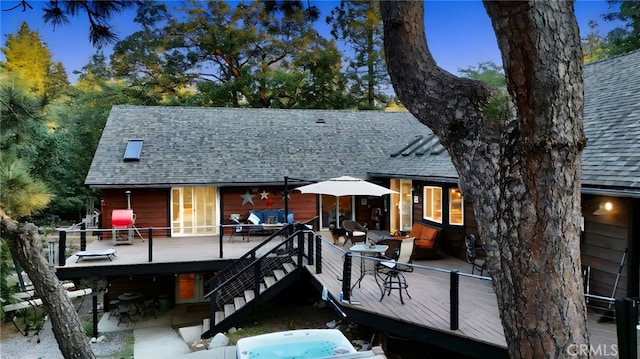 32383 Pine Manor Ln Unit 634, Running Springs, CA 92382 - back of house with a shingled roof, a wooden deck, stairs, and outdoor dining space