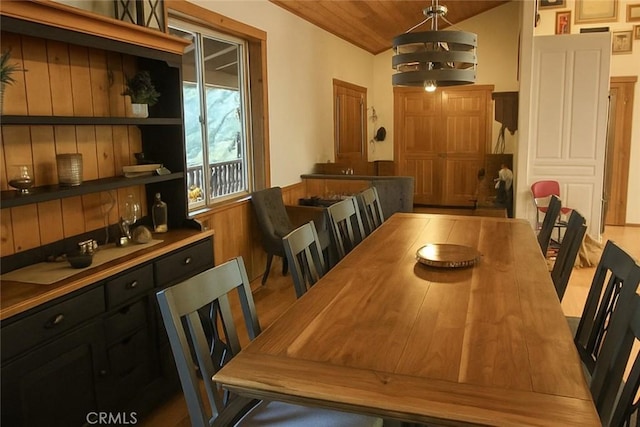 32383 Pine Manor Ln Unit 634, Running Springs, CA 92382 - dining space featuring a chandelier, wainscoting, and vaulted ceiling