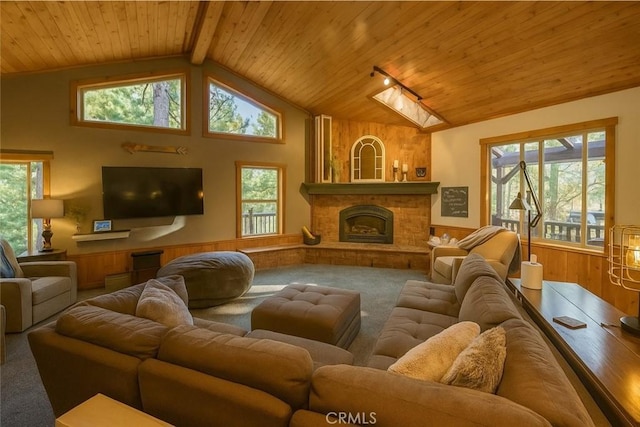 32383 Pine Manor Ln Unit 634, Running Springs, CA 92382 - living area with wooden ceiling, carpet flooring, wainscoting, plenty of natural light, and a fireplace with raised hearth