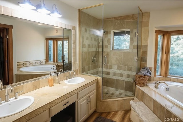 32383 Pine Manor Ln Unit 634, Running Springs, CA 92382 - bathroom featuring a garden tub, a stall shower, double vanity, and wood finished floors