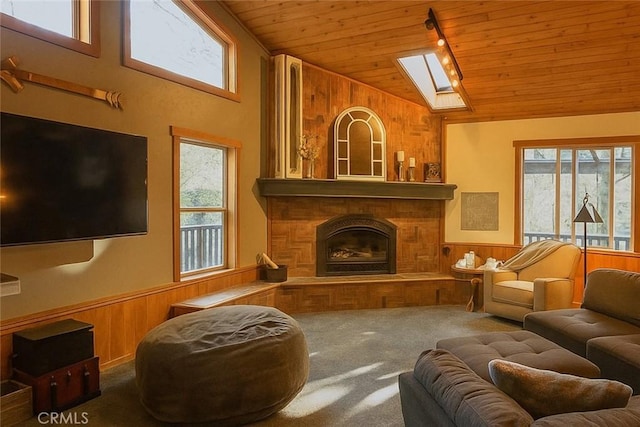 32383 Pine Manor Ln Unit 634, Running Springs, CA 92382 - carpeted living room featuring wooden ceiling, wood walls, vaulted ceiling, plenty of natural light, and a wainscoted wall