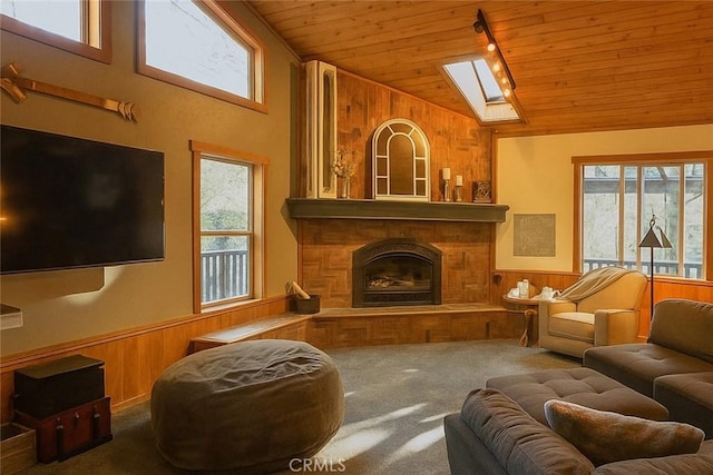 32383 Pine Manor Ln Unit 634, Running Springs, CA 92382 - living area with wooden ceiling, wooden walls, carpet flooring, vaulted ceiling, and healthy amount of natural light