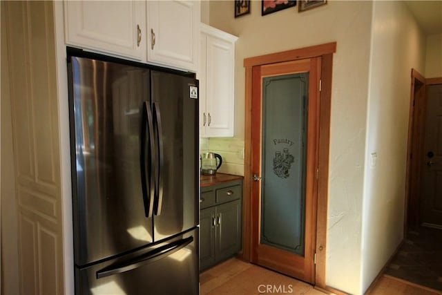 32383 Pine Manor Ln Unit 634, Running Springs, CA 92382 - kitchen featuring freestanding refrigerator, white cabinets, and dark countertops