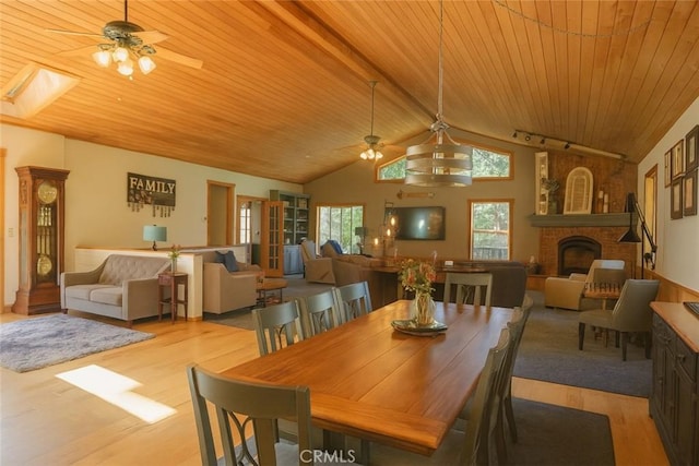 32383 Pine Manor Ln Unit 634, Running Springs, CA 92382 - dining space featuring ceiling fan, a fireplace, wood ceiling, lofted ceiling, and wood finished floors