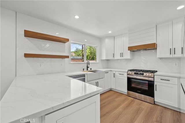 19548 Cedarcreek St, Canyon Country, CA 91351 - kitchen featuring gas range, white cabinets, decorative backsplash, and recessed lighting