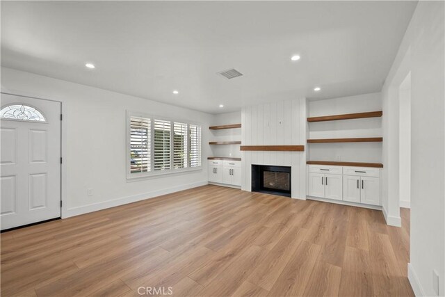 19548 Cedarcreek St, Canyon Country, CA 91351 - unfurnished living room with light wood-style floors, a large fireplace, and recessed lighting