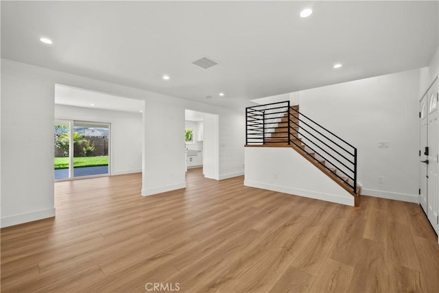 19548 Cedarcreek St, Canyon Country, CA 91351 - unfurnished living room featuring stairway, light wood finished floors, and recessed lighting