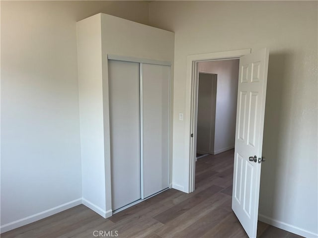 1231 Webster St, Redlands, CA 92374 - unfurnished bedroom featuring wood finished floors and a closet