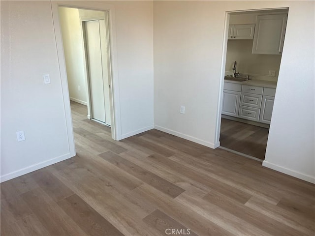 1231 Webster St, Redlands, CA 92374 - empty room featuring a sink and light wood-style flooring