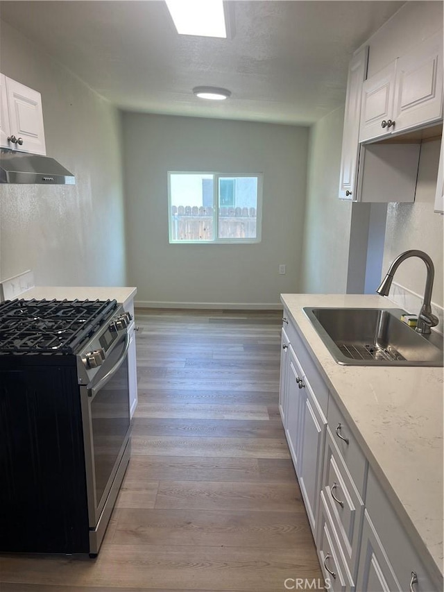 1231 Webster St, Redlands, CA 92374 - kitchen featuring gas range, exhaust hood, white cabinets, and light wood-type flooring