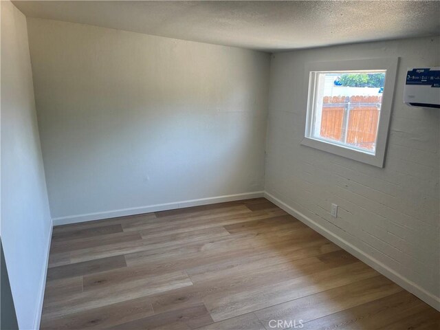 1231 Webster St, Redlands, CA 92374 - spare room featuring wood finished floors and a textured ceiling
