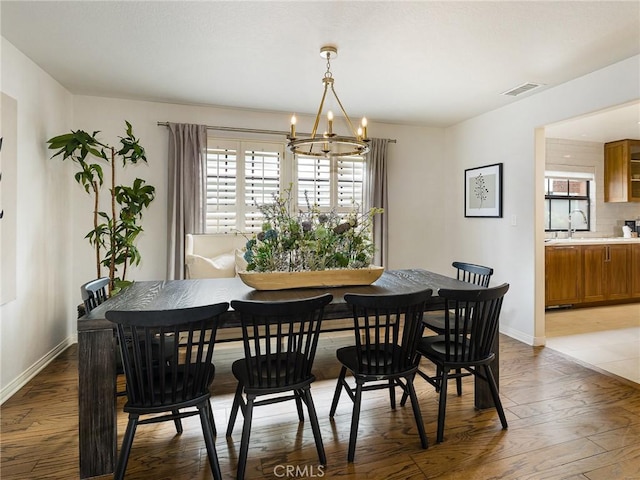 502 Washington St, El Segundo, CA 90245 - dining room featuring a chandelier and wood finished floors