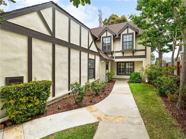 502 Washington St, El Segundo, CA 90245 - tudor-style house featuring stucco siding, french doors, and a shingled roof