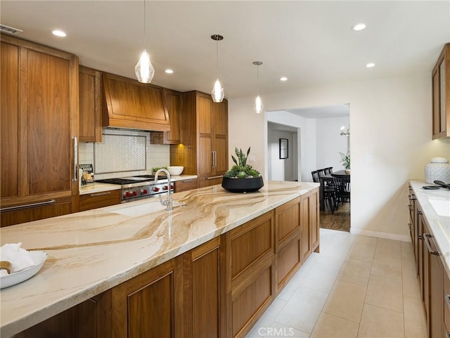 502 Washington St, El Segundo, CA 90245 - kitchen with premium range hood, brown cabinetry, tasteful backsplash, recessed lighting, and hanging light fixtures