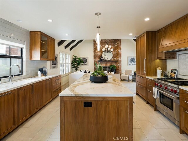 502 Washington St, El Segundo, CA 90245 - kitchen with premium range, decorative backsplash, a brick fireplace, a center island, and light tile patterned flooring