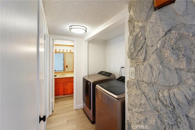 750 Via Los Santos, San Dimas, CA 91773 - laundry area featuring independent washer and dryer, light wood-style flooring, and a textured ceiling