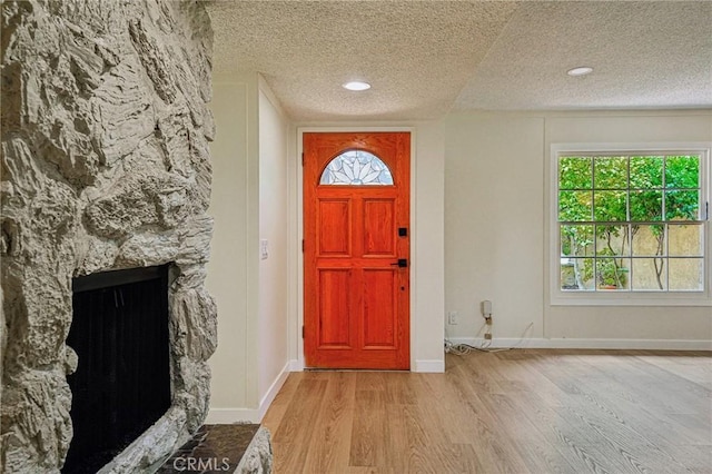 750 Via Los Santos, San Dimas, CA 91773 - entryway with a textured ceiling, wood finished floors, recessed lighting, and a stone fireplace