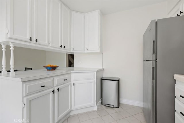 2811 Via Topacio, Carlsbad, CA 92010 - kitchen featuring freestanding refrigerator, white cabinetry, light countertops, and light tile patterned floors