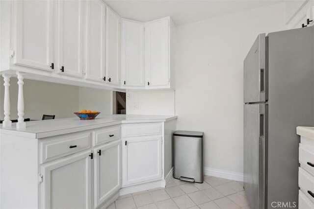 2811 Via Topacio, Carlsbad, CA 92010 - kitchen featuring freestanding refrigerator, white cabinetry, light countertops, and light tile patterned floors