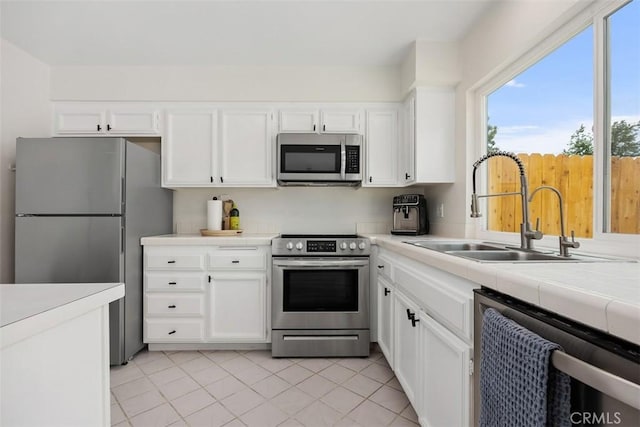 2811 Via Topacio, Carlsbad, CA 92010 - kitchen with appliances with stainless steel finishes, white cabinets, and tile counters