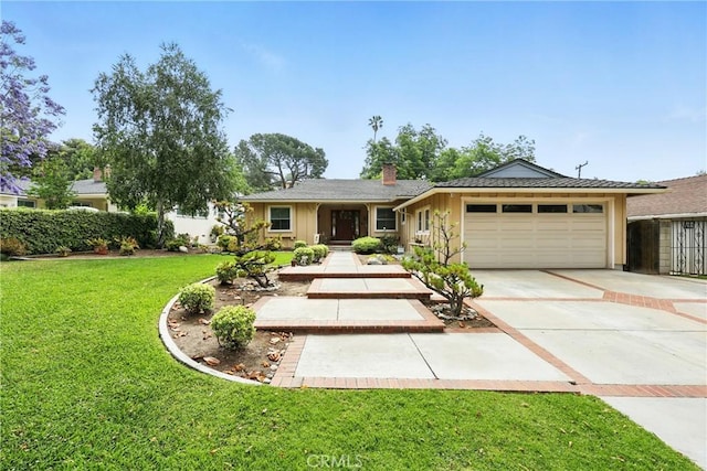 7604 Forest Ave, Whittier, CA 90602 - single story home with concrete driveway, a garage, board and batten siding, a front yard, and a chimney