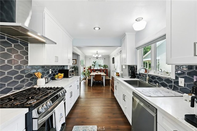 7604 Forest Ave, Whittier, CA 90602 - kitchen featuring appliances with stainless steel finishes, wall chimney exhaust hood, white cabinets, light countertops, and recessed lighting