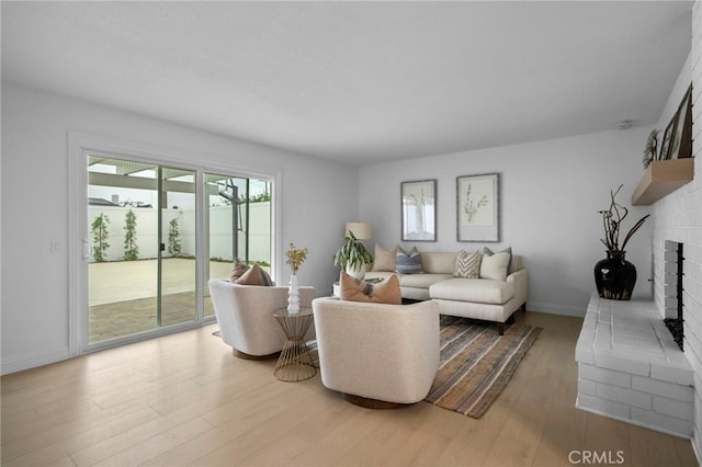 644 Kenoak Dr, Placentia, CA 92870 - living area featuring a brick fireplace and wood finished floors