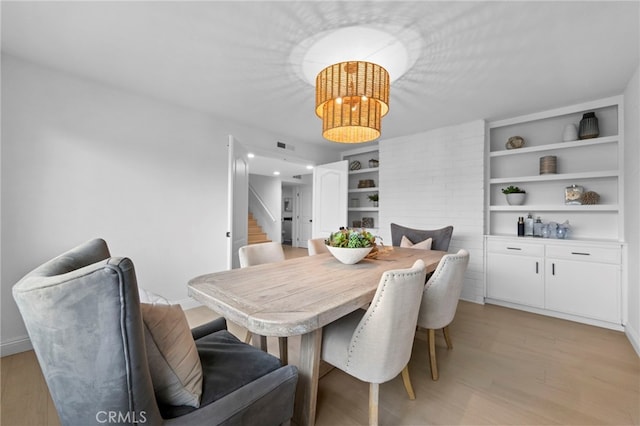 644 Kenoak Dr, Placentia, CA 92870 - dining space featuring light wood-type flooring, stairs, a chandelier, and built in shelves